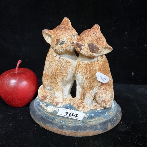 164 - A heavy cast metal door stop in the form of two affectionately cuddling cats. Gorgeous age to this p... 