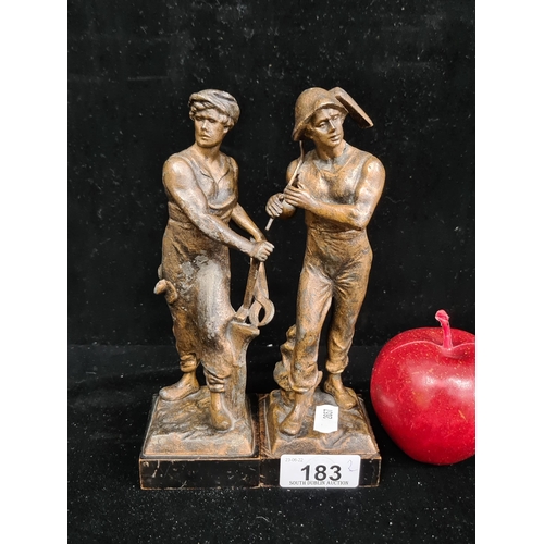 183 - A handsome pair of spelter sculptures of a blacksmith and farmhand on wooden plinth base.