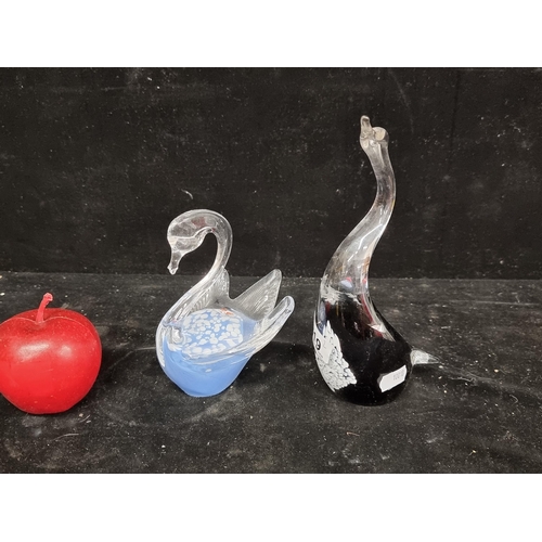 219 - A pair of art glass paper weights in the shapes of swans. One with a speckled blue finish, accompani... 