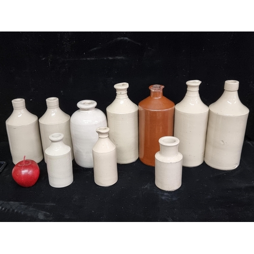 241 - A lot of ten antique stoneware jars and ink bottles. In beige glaze and various sizes.