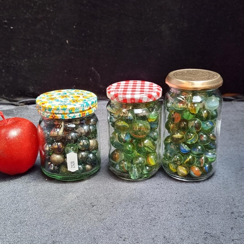 262 - Three glass jars packed full of vintage marbles of various sizes, including metal examples. A great ... 