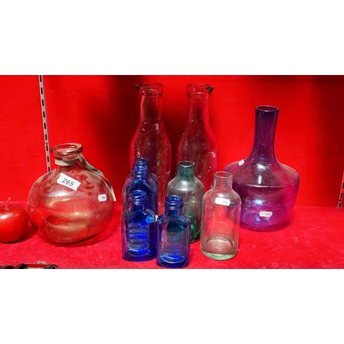 265 - A good lot of vintage glass bottles, including two ''Absolutely Pure Milk'' bottles and two blue gla... 