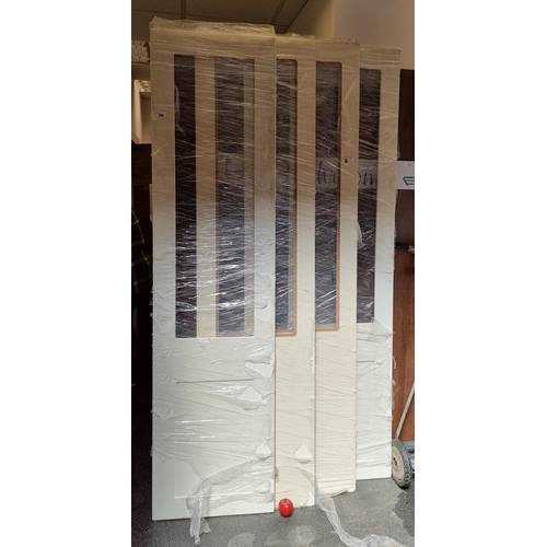 280 - Four lovely wardrobe doors with glass panels and a cream finish. Mm: 225cm x 58cm each NEW.