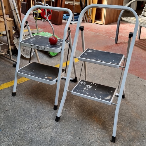 299 - Two very handy fold away step ladders.