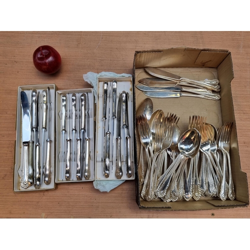 311 - A large collection of sheffeild stainless steel tableware including knives, forks and spoons.