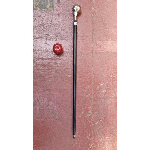 313 - A very heavy cane with black wood stick and chrome skull handle.