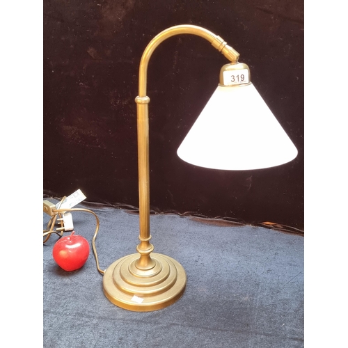 319 - A handsome brass table lamp with fluted pedestaled base and frosted glass shade. With three pronged ... 