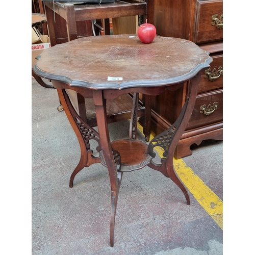 329 - A very attractive antique occasion table. With pie crust edge, draped apron and under tier supported... 