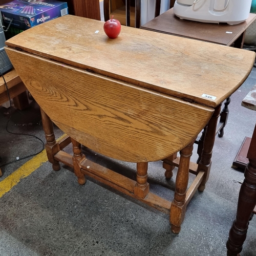 346 - A nice example of an antique oak drop leaf table with gate legs.