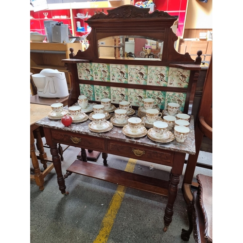 349 - A fantastic example of an Edwardian wash stand. With a gallery back bevelled mirror, tile splashback... 