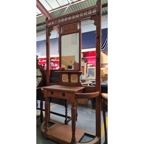 351 - A handsomely Edwardian six hook coat stand. With a central mirror, pullout drawer, umbrella stand an... 