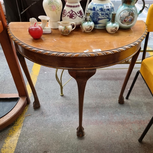 353 - A vintage demi-lune table with ball and claw feet and carved rope design to the top. L90cms, H77 cms... 