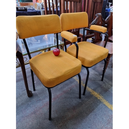 354 - A pair of industrial mid century chairs, one with arm rests. Upholstered in fire yellow fabric on bl... 