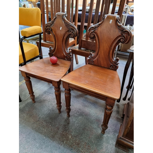 355 - A pair of Lovely  Victorian mahogany hall chairs. With shield back, carved front legs and solid seat... 