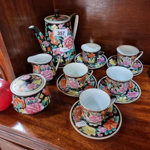 357 - A sixteen-piece coffee set in an attractive Famile Noir pattern- with ornaments of colourful chrysan... 