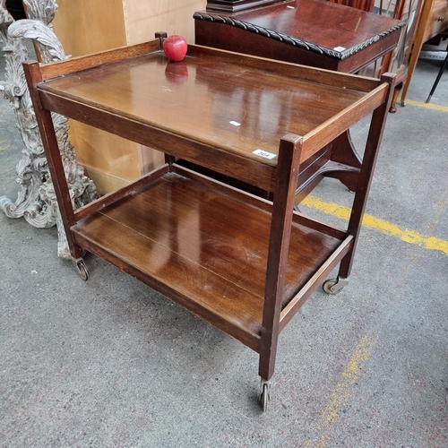 364 - A nice example of a two-tier mid century hostess trolley with gallery edges and original wheels. L74... 