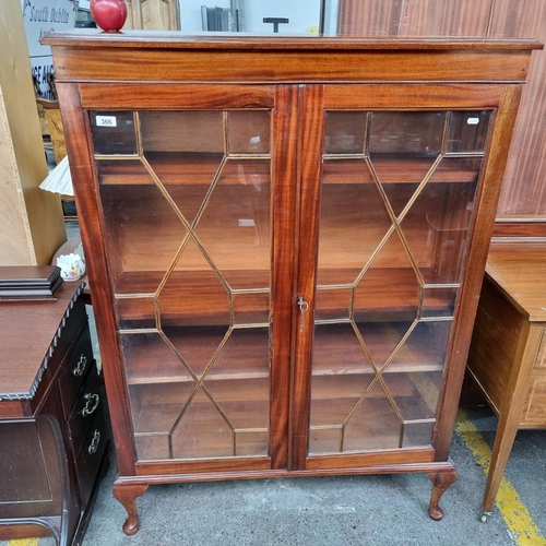 366 - A classic Duncan Phyfe style book case with astro-glaze front door, four shelves to the interior and... 