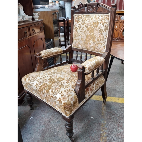 370 - A beautiful vintage open arm chair with intricately carved floral details, turned features and broca... 