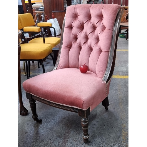 371 - A lovely antique button back nursing chair, with a wide seat and turned legs on castors. Upholstered... 