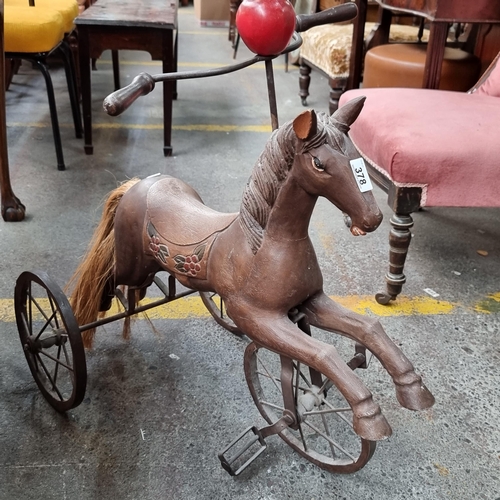 378 - An exceptional Victorian style horse tricycle. This charming piece features a carved wooden horse wi... 