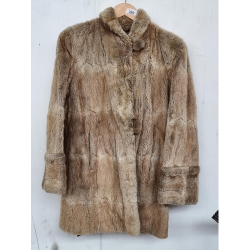 399 - A beautiful vintage mid-length ladies fur coat in beige. With wide cuffs and fur buttons. With ''Swi... 