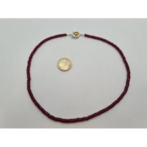 43 - A beautiful beaded 138 cts faceted ruby gemstone necklace with citrine set locking mechanism. Sterli... 