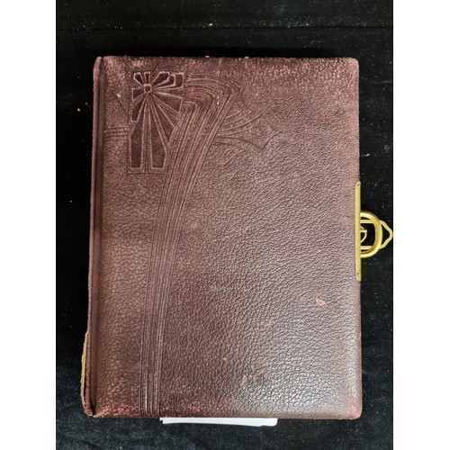 153 - A large vintage, leather bound photo album with brass clasp and gilded pages. Features colourful ill... 