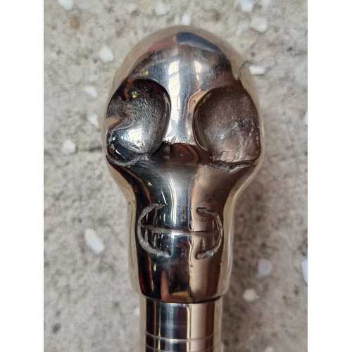 313 - A very heavy cane with black wood stick and chrome skull handle.