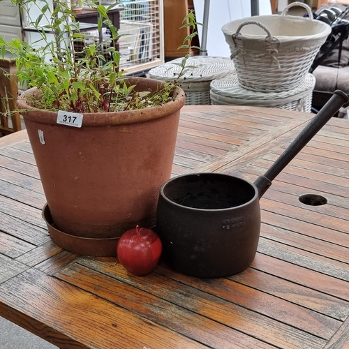 317 - Two lovely garden planters including a cast metal example with handles and a terracotta pot.