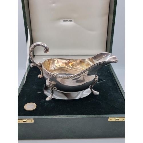 403 - Star Lot: A fine example of an Irish silver gravy boat, with a delicate scroll 