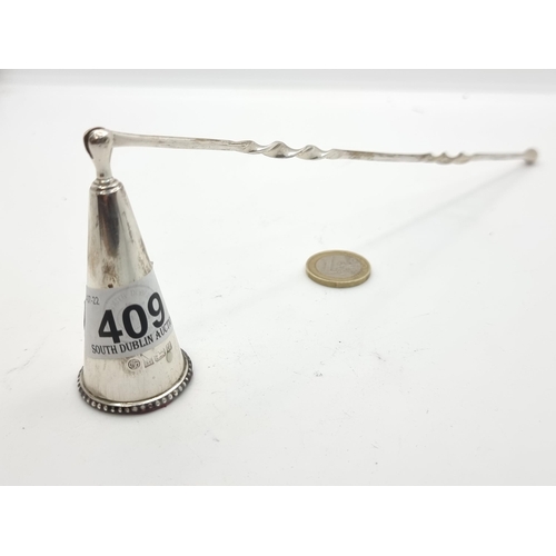 409 - A fine example of a sterling silver candle snuffer with barely twist stem and intricate bell. Hallma... 