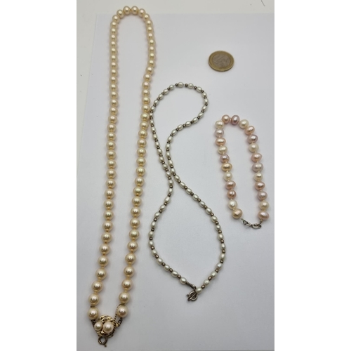 421 - Three pearl set items, including a stunning pearl necklace with an inlayed pearl clasp (length 56cm)... 