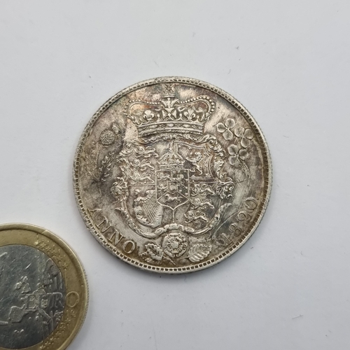 431 - A large rare silver George III coin, with profile facing to the left. Dated 1820.