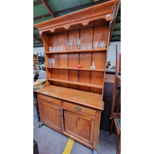 498 - A fantastic antique Welsh dresser with ample storage courtesy of three shelves, a deep cabinet to ba... 