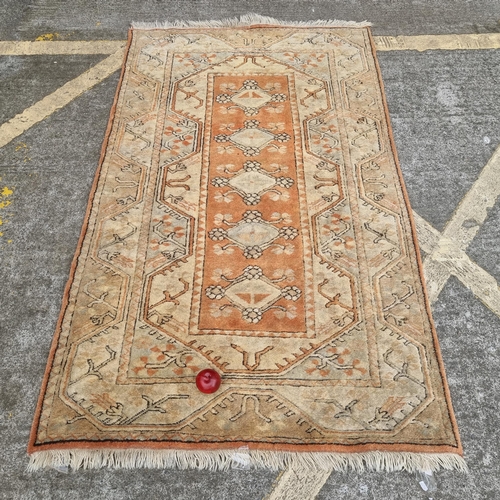 644 - A heavy rug, highly decorative with a geometric pattern in shades of peach and fawn. heavy lovely qu... 