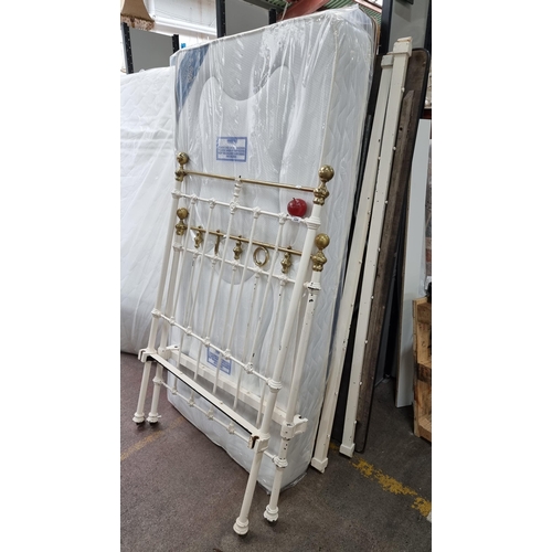 654 - A fantastic vintage cast iron bed frame with brass hoppers, complete with an as new single bed mattr... 