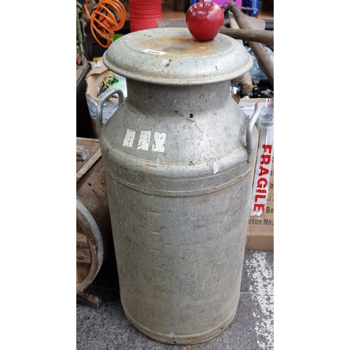 668 - A large aluminium ten gallon milk churn. Marked 