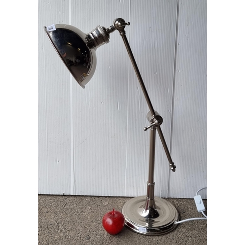 756 - A tall heavy articulated desk lamp with chrome finish.