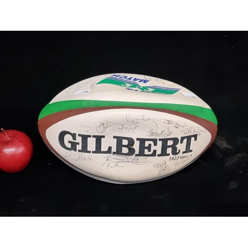 765 - A signed Harlequin rugby ball with roughly 28 signatures from various players.