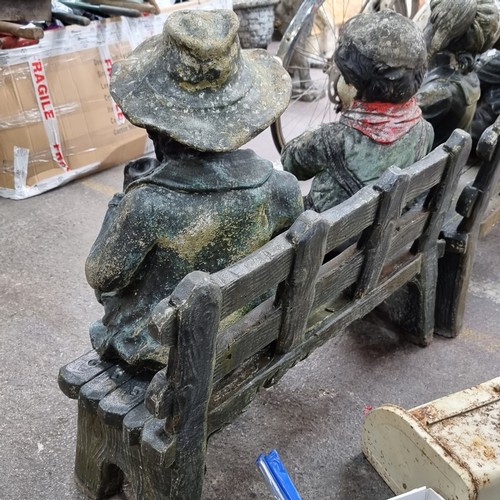 219 - A heavy charming bench with 2 heavy statues inc a young boy with his grandfather in three separate p... 