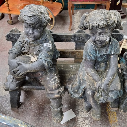 688 - A very heavy garden bench with two very heavy stone garden figures of a young boy and girl. Sweet ch... 