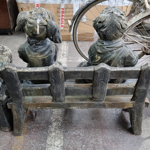 688 - A very heavy garden bench with two very heavy stone garden figures of a young boy and girl. Sweet ch... 