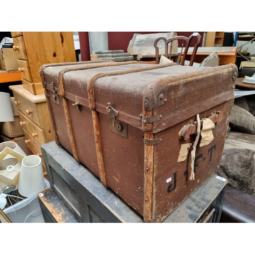 299 - A very large antique travelling trunk with canvas finish, bent wood supports and marked JFT to the s... 