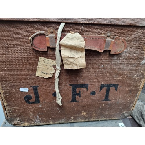 299 - A very large antique travelling trunk with canvas finish, bent wood supports and marked JFT to the s... 