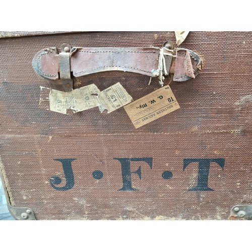 299 - A very large antique travelling trunk with canvas finish, bent wood supports and marked JFT to the s... 