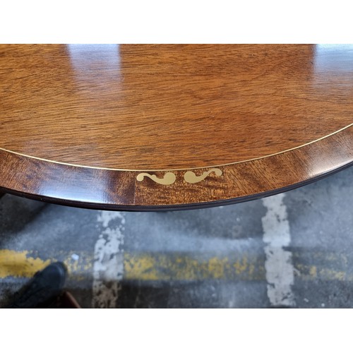 371 - Star lot : A beautiful dining suite comprising of an extendable dining table with brass scroll and s... 