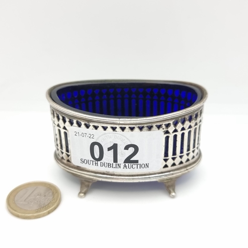 12 - An attractive antique lattice design sterling silver cruet, with Bristol blue liner and four pawed f... 