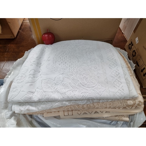 340 - A large collection of white and cream lace table cloths in very good condition. Believed to be new o... 