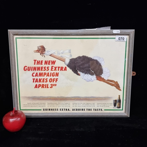 70 - A original vintage advertisement poster for Guinness Extra Stout featuring a comical image of a flyi... 