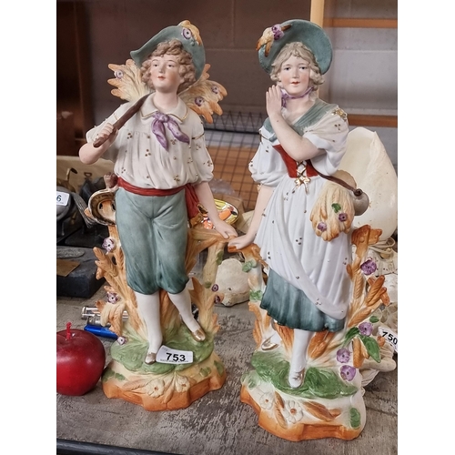 753 - A pair of tall antique German bisque figures, depicting a male and female reaping the harvest with s... 